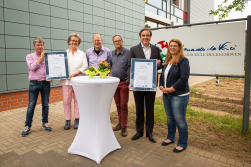 Das Foto zeigt die Schulleiterin Petra Mersmann mit den Vertretern der Firmen vor der Schule,